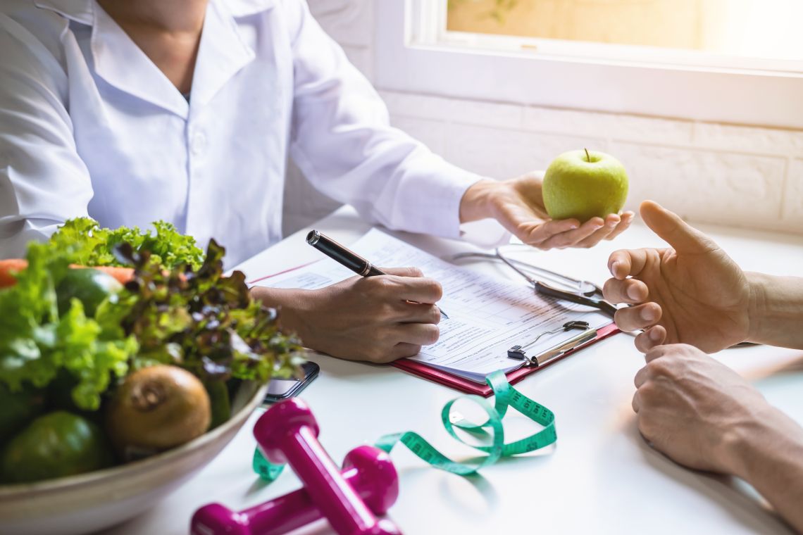 Ein Ernährungsberater füllt einen Fragebogen aus und berät einen Patienten