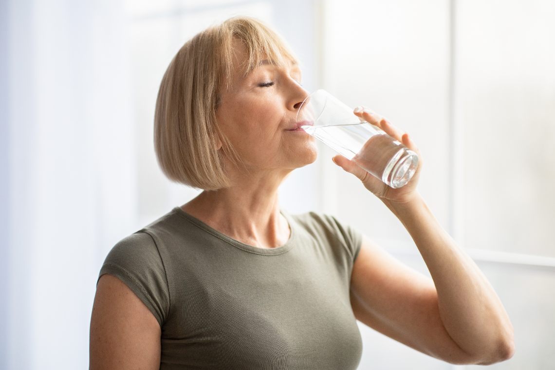 Frau trinkt ein Glas Wasser